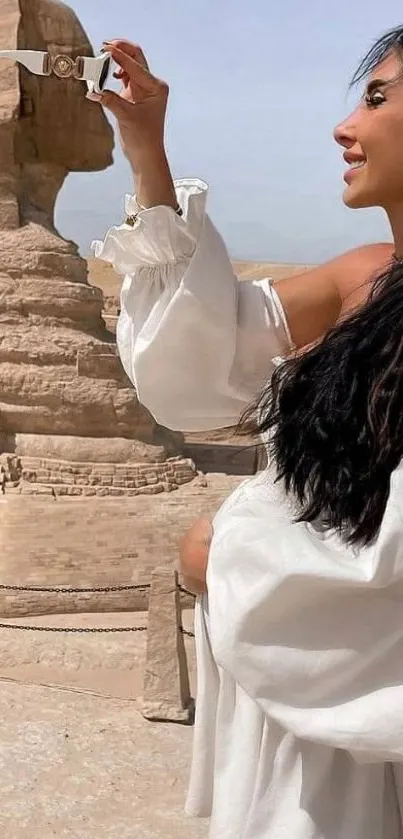 Woman posing with the Sphinx, set in Egypt's desert landscape.