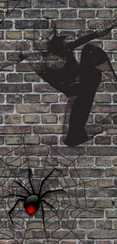 Spider-themed artwork on a brick wall background featuring a web and spider design.