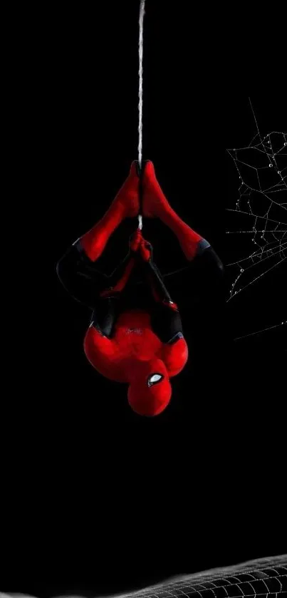 Spiderman hanging midair against a black background with web.