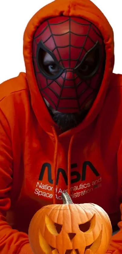 Spiderman mask in orange hoodie holding a pumpkin.