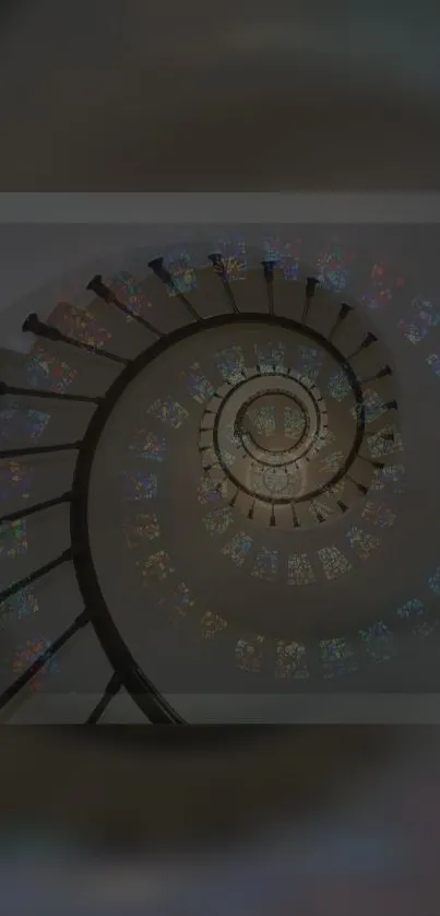 Spiral staircase with colorful stained glass patterns.