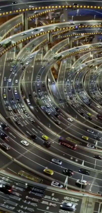 Spiral urban highway with vibrant traffic lights at night.