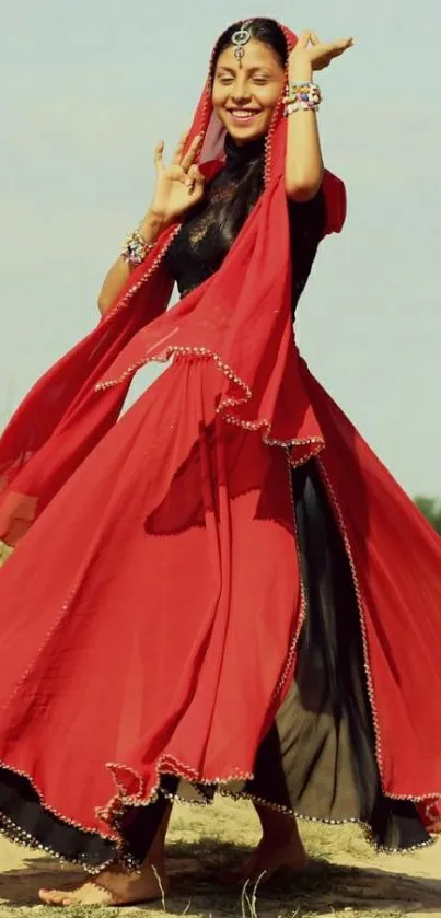 Joyful dancer in vibrant red dress spins under clear skies in mobile wallpaper.