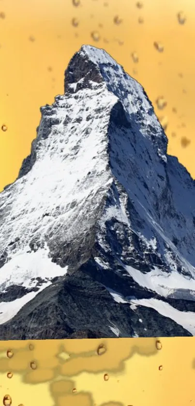 Snow-covered mountain peak with amber backdrop and droplets.