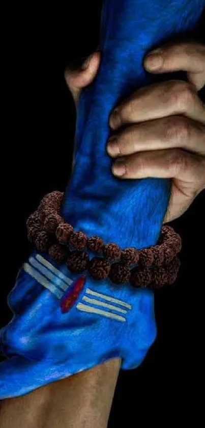 Spiritual hands with blue hues and Rudraksha beads in a powerful embrace.