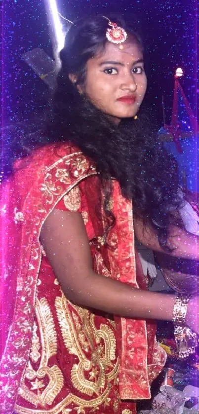 Woman in red traditional attire at a vibrant cultural festival.