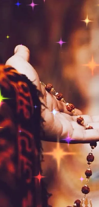 Hand holding prayer beads with colorful stars.