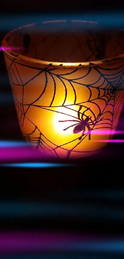 Glowing candle with spider web design, perfect for Halloween ambiance.