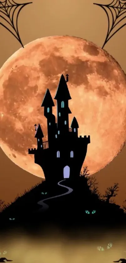 Silhouette of a spooky castle against a full orange moon with spiderwebs.