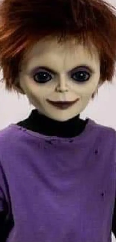 A spooky doll with dark eyes and a purple shirt stands on a plain background.