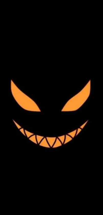 Glowing orange face on a black background, spooky Halloween wallpaper.