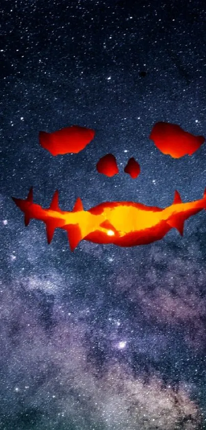 Galaxy wallpaper with a glowing pumpkin face in dark blue starry background.