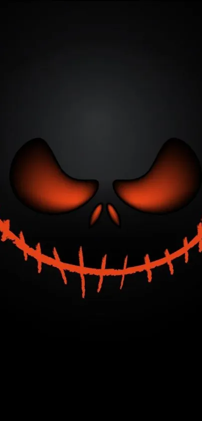 Dark mobile wallpaper with a spooky glowing grin for Halloween.