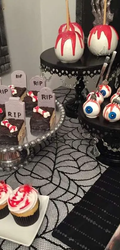 Halloween dessert table with spooky treats and grave-themed cupcakes.