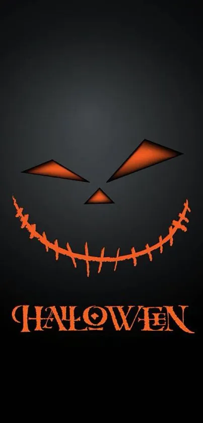 Halloween wallpaper with sinister orange smile on black background.