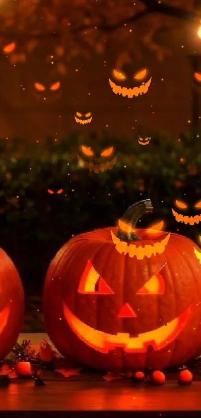 Carved pumpkins lit at night on a table.