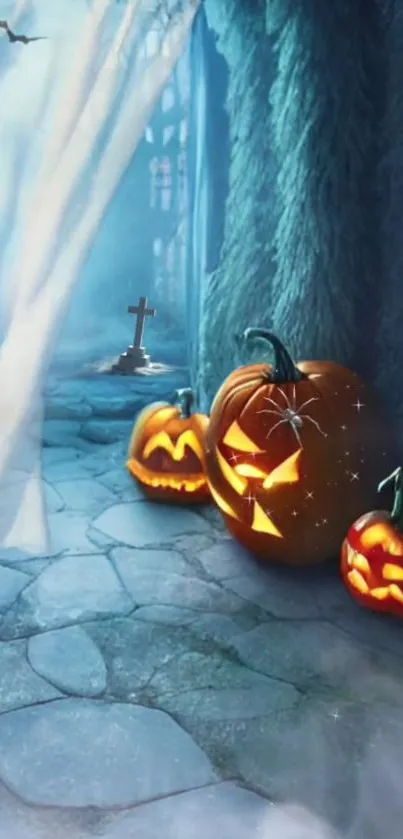 Lit pumpkins on a misty stone path in blue hues, creating a spooky Halloween scene.