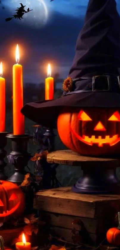 Halloween pumpkin with witch hat and candles in dark setting.