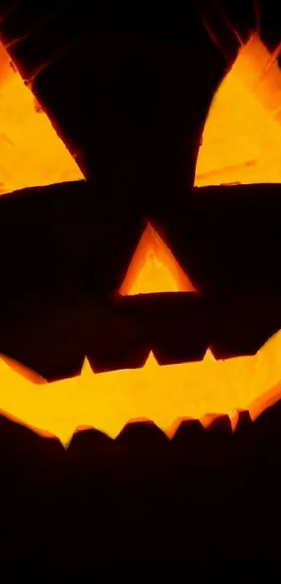 Glowing jack-o'-lantern in dark background for Halloween.