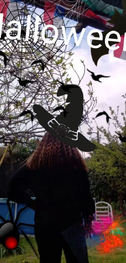 Eerie Halloween wallpaper with witch silhouette and garden background.