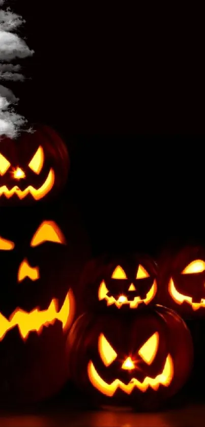 Spooky Jack-o'-lanterns glowing in darkness.