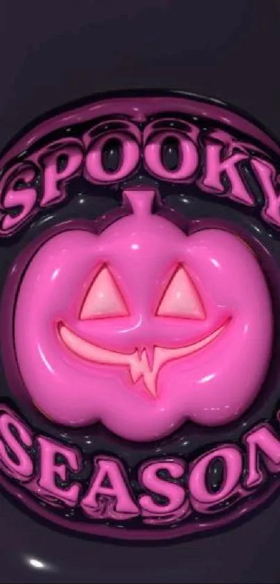 Pink pumpkin with a spooky face and text 'Spooky Season' on dark background.