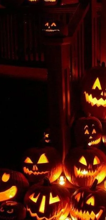 Halloween wallpaper with glowing pumpkins on stairs.