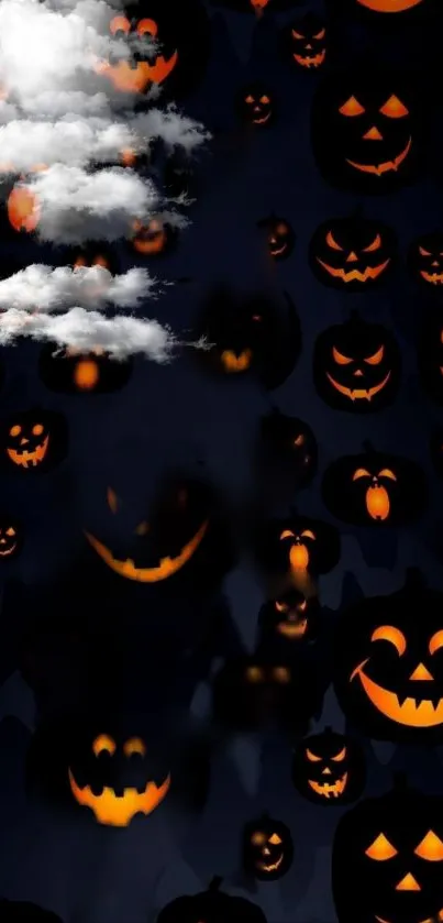 Dark wallpaper with glowing pumpkins and eerie clouds.