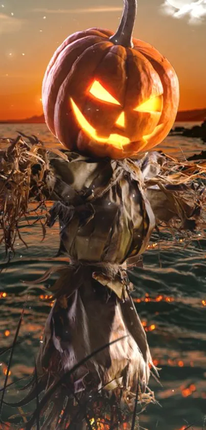 Spooky pumpkin scarecrow at sunset over ocean.