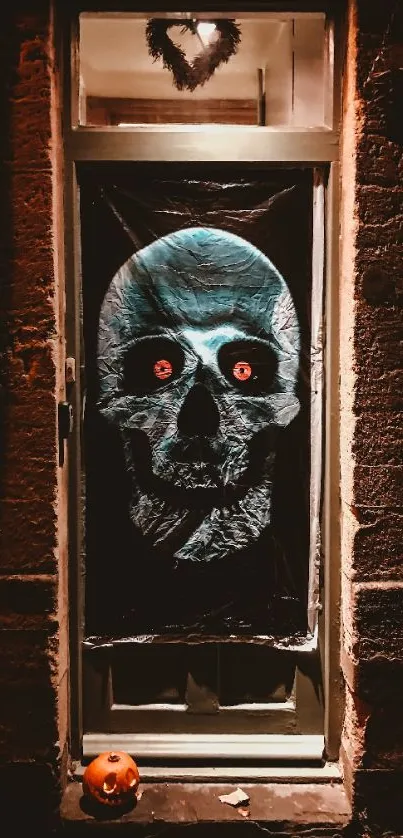 Door with a glowing skull decoration and a small pumpkin.