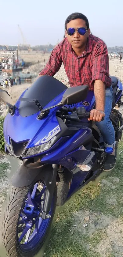 Sports bike and rider in urban setting with blue hues.