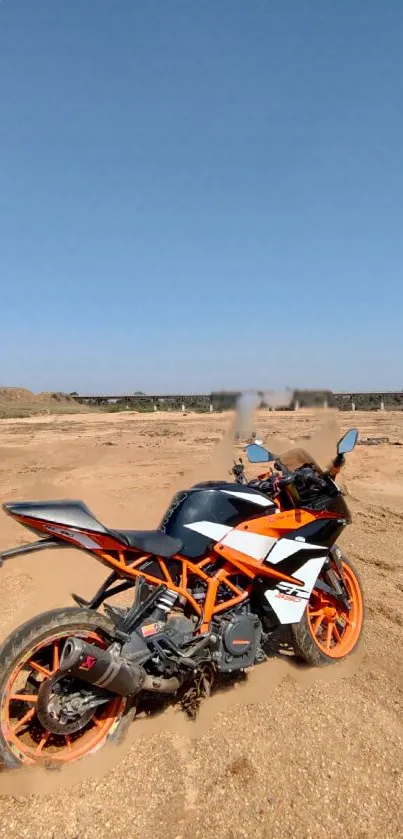 Sport bike on desert terrain under clear blue sky.