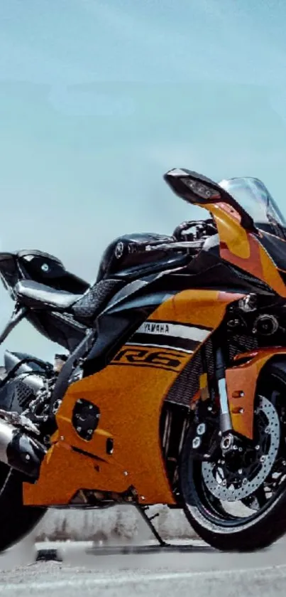 Sport bike on open road under blue sky.