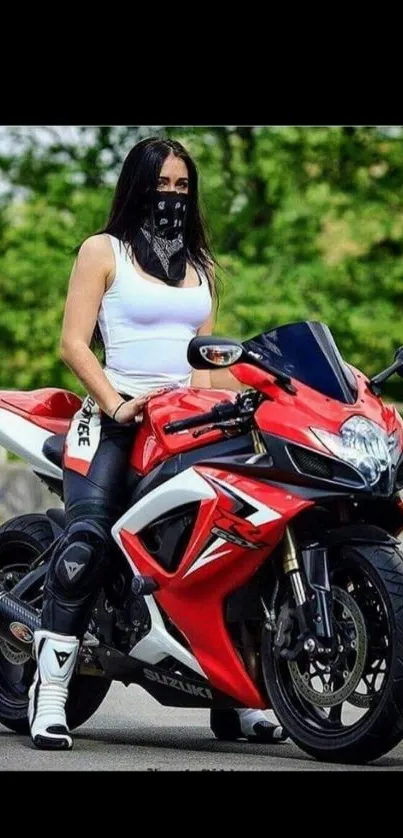 Woman on red sport bike with scenic view.