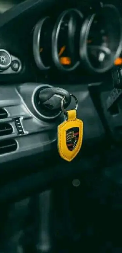 Luxury car dashboard with yellow keychain in ignition.