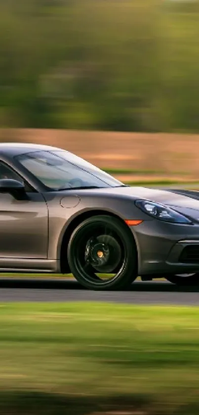 Sleek sports car driving on a scenic road with greenery.