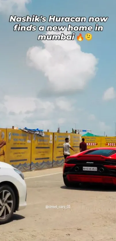 Red sports car in vibrant city background.