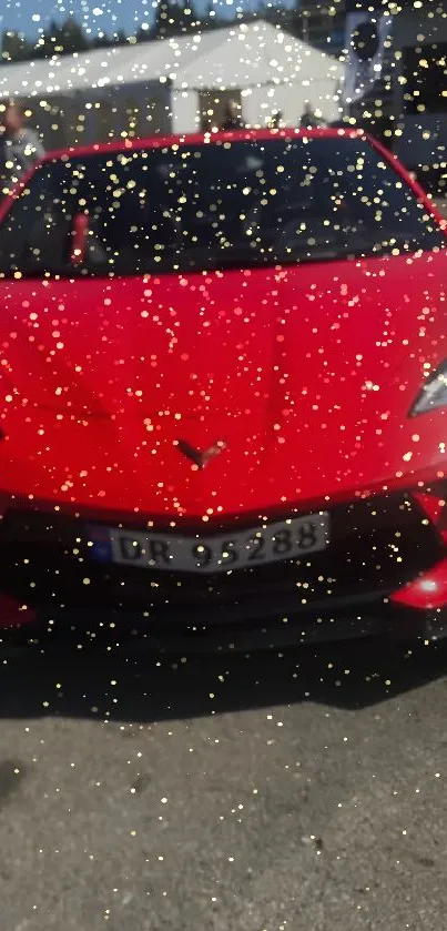 Red sportscar with gold glitter accents in dynamic wallpaper.