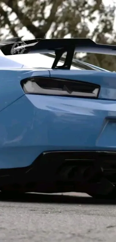 Sleek blue sports car with rear spoiler.