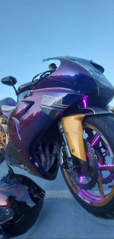 Sporty motorcycle with purple and gold accents on open road.