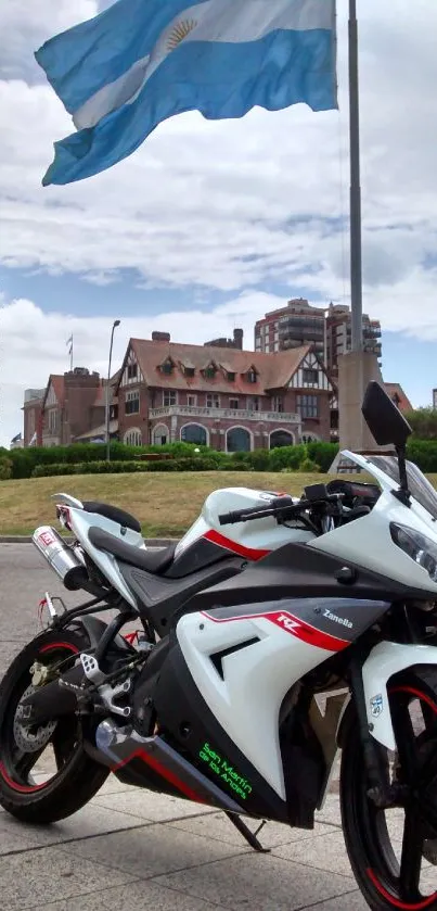 Sport motorcycle near a waving flag with an urban backdrop.