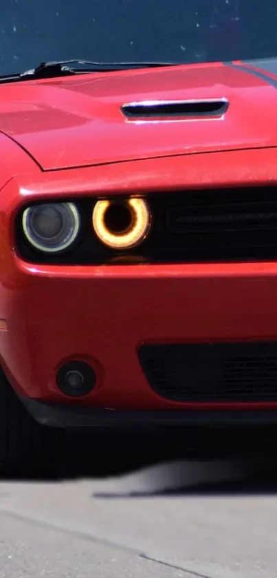 Red muscle car with black stripes and fierce headlights.