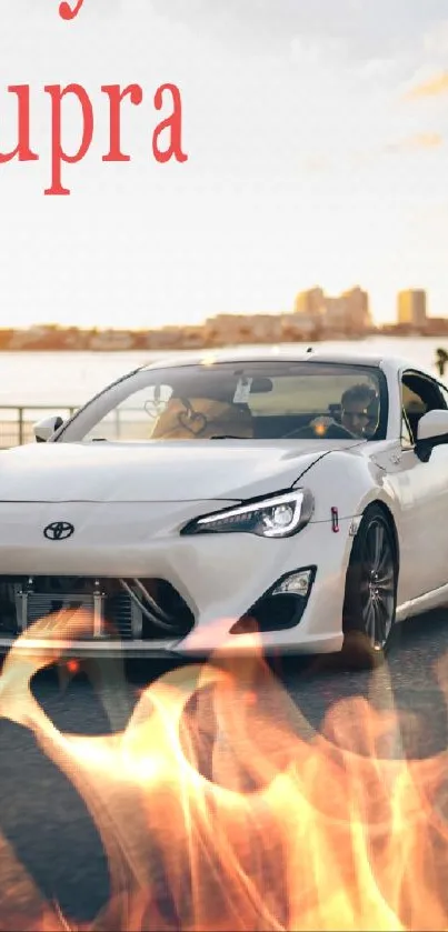 White sports car with flames in urban setting.