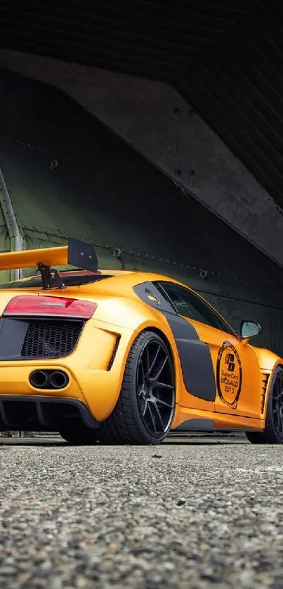 Yellow sports car parked under a dark structure, showcasing sleek design.