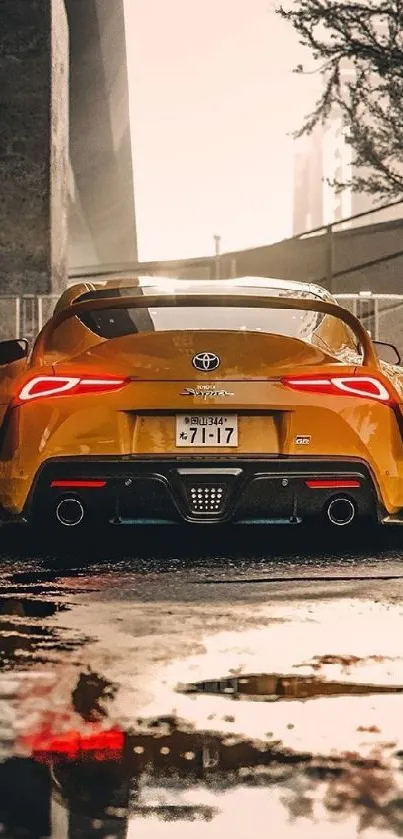 Yellow sports car parked under a bridge in urban landscape.