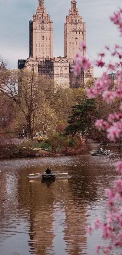 Cityscape with cherry blossoms and calm water reflection.