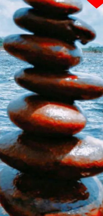 Serene mobile wallpaper of stacked stones by a tranquil lake.