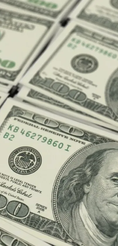 Close-up image of stacked 100 dollar bills in rows.