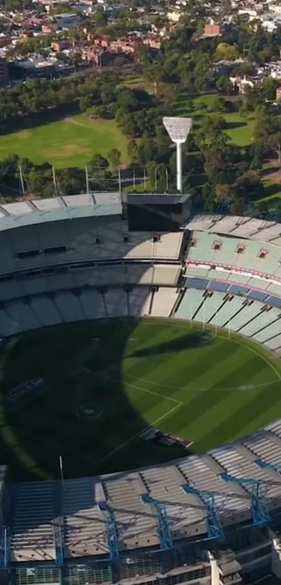 Aerial view of a large stadium surrounded by green landscapes.