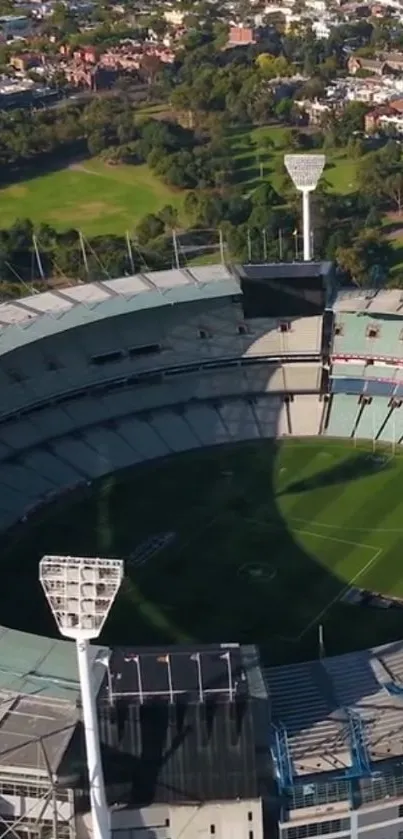 Aerial view of a large stadium surrounded by greenery.